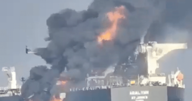 A burning oil tanker, the ABAL TIER, at sea.