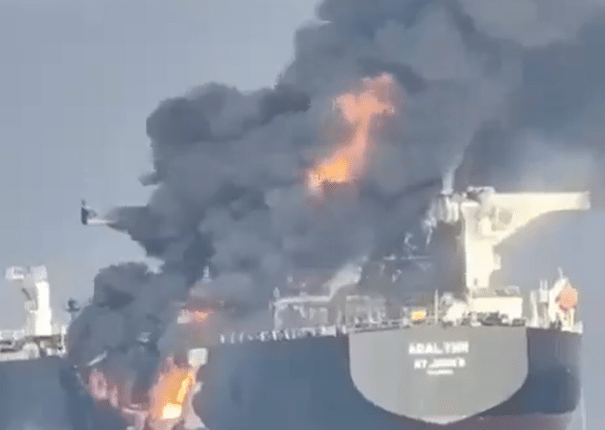 A burning oil tanker, the ABAL TIER, at sea.