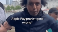 Man being detained, Apple Pay prank gone wrong, London Eye in background.