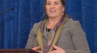 Photo of Joanna Miller speaking at a podium.