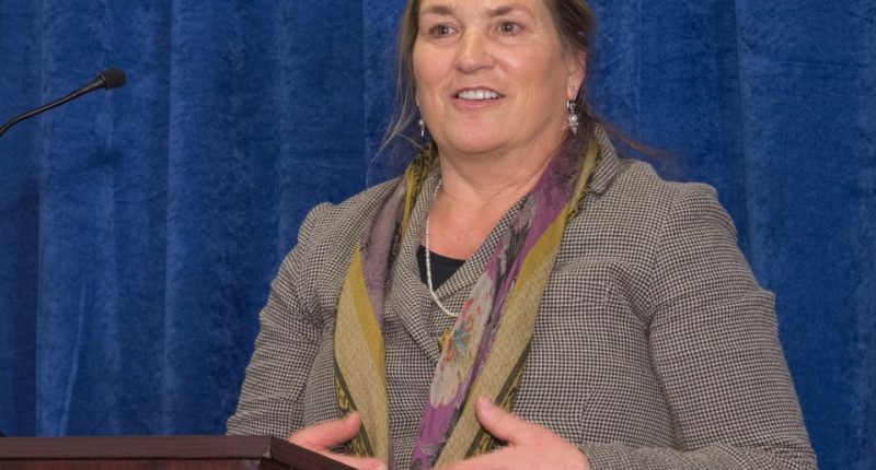 Photo of Joanna Miller speaking at a podium.