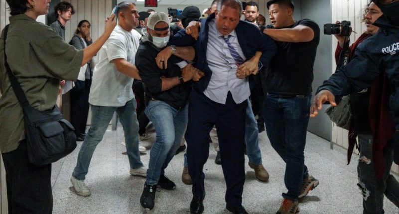 New York City Comptroller Brad Lander being arrested by ICE and FBI agents outside a federal immigration court.