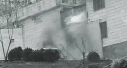 Grainy security camera footage of an explosion at Evin prison in Iran.
