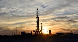 Drilling rigs operate at sunset in Midland, Texas