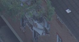 One hospitalised after gas explosion blows wall apart in Sydney apartment block