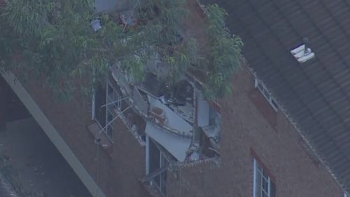 One hospitalised after gas explosion blows wall apart in Sydney apartment block