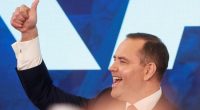 Karol Nawrocki giving a thumbs-up sign