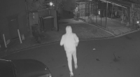 At the same location 24 hours earlier, a hooded figure is seen running in and out before the shop goes up in flames.
