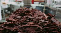 Closeup of a pile of beef jerky in a commercial kitchen.