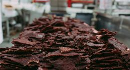 Closeup of a pile of beef jerky in a commercial kitchen.