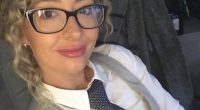 Selfie of a woman wearing glasses and a tie.