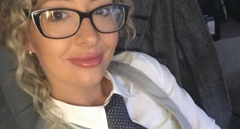 Selfie of a woman wearing glasses and a tie.