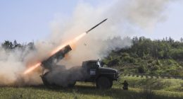 A BM-21 Grad multiple rocket launcher firing a missile.