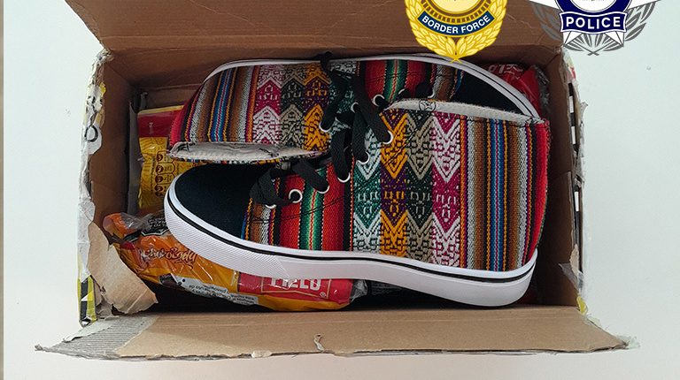 Two men have been sentenced after trying to smuggle 100 grams of cocaine into the Northern Territory, hidden inside sneakers.