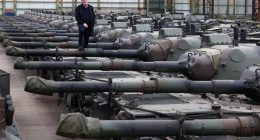 Freddy Versluys, CEO of OIP Land Systems, standing on Leopard 1 tanks.