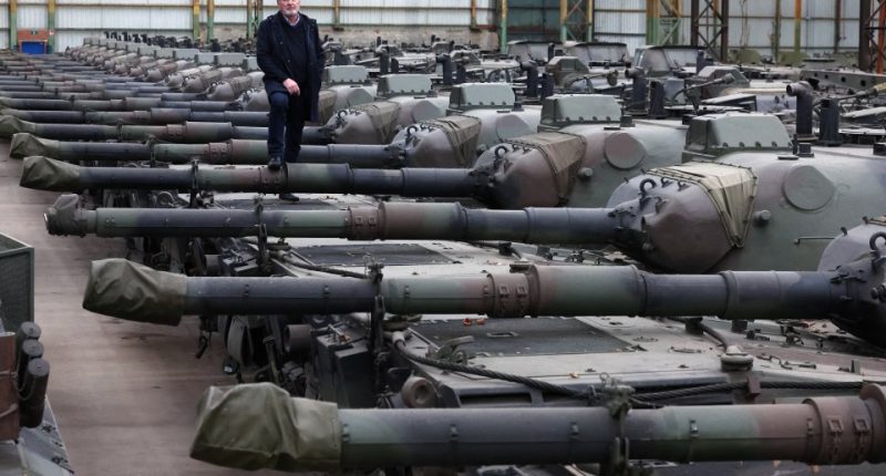 Freddy Versluys, CEO of OIP Land Systems, standing on Leopard 1 tanks.