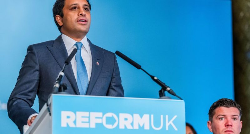 A man in a suit speaks at a Reform UK press conference.