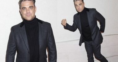 Robbie Williams shows off slimmer figure in grey suit at Q Awards