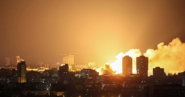 Fire and smoke rising over a city at night after a drone strike.