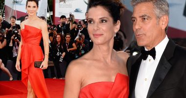Sandra Bullock stuns in a scarlet strapless dress as she joins George Clooney at the Venice Film Festival premiere of Gravity
