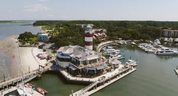 Aerial view of the Hilton Head lighthouse, marina, and surrounding area.