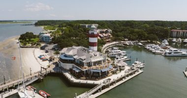 Aerial view of the Hilton Head lighthouse, marina, and surrounding area.