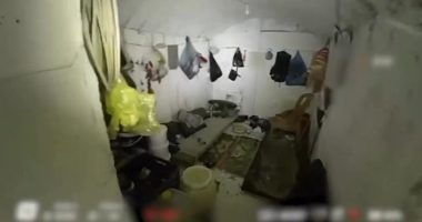 Drone footage of a cluttered underground room.
