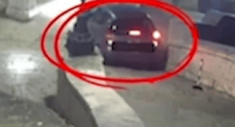Security camera image of a car at night.