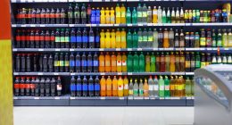 Supermarket shelves stocked with various beverages for sale.