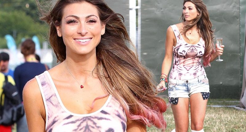 Showing off her wild side: Luisa Zissman parties in tiger print body and tiny denim shorts as she sups bubbly at V Festival