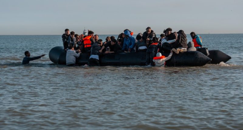 Migrants in a small inflatable boat crossing the English Channel.