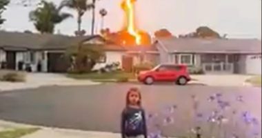 Lightning bolt striking a house near a young girl.