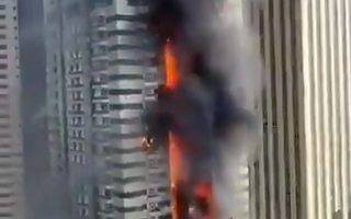 Fire engulfing a Dubai Marina skyscraper; 3,820 evacuated.