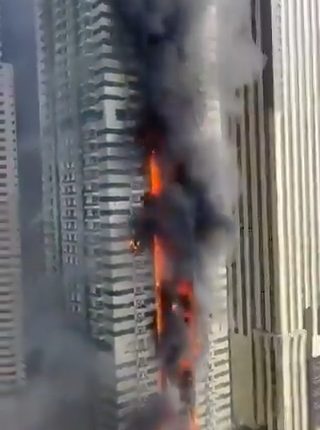 Fire engulfing a Dubai Marina skyscraper; 3,820 evacuated.