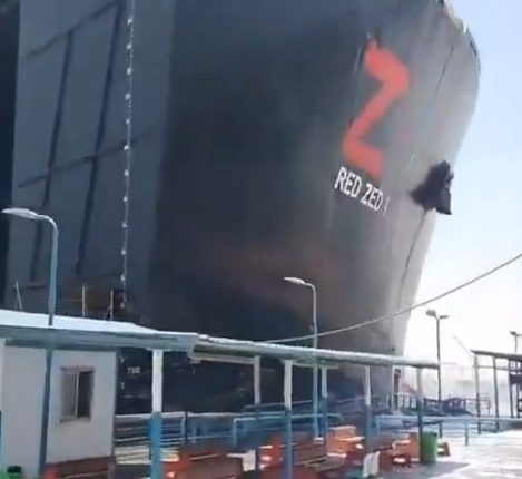 A 700ft cargo ship crashing into a Suez Canal port.