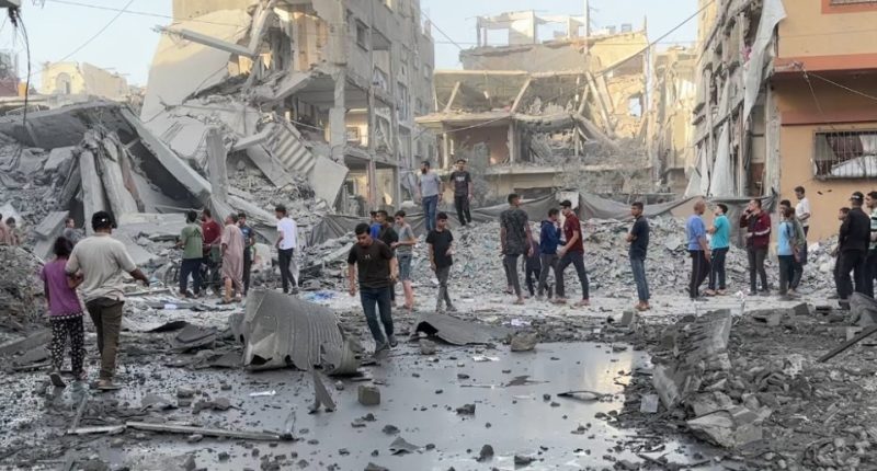 Destruction and people surveying the damage in Gaza City after Israeli airstrikes.