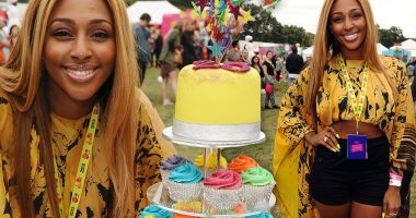 That's one way to celebrate! Alexandra Burke marks her 25th birthday at V Festival with multi-coloured five-tier cake