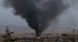 Smoke rising from a burning building in Tehran, following an Israeli strike.