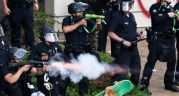 LAPD officers firing less-lethal projectiles at protesters.