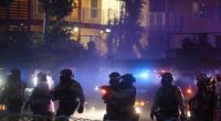 Protesters clashing with law enforcement during a demonstration against immigration raids.