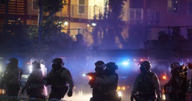Protesters clashing with law enforcement during a demonstration against immigration raids.