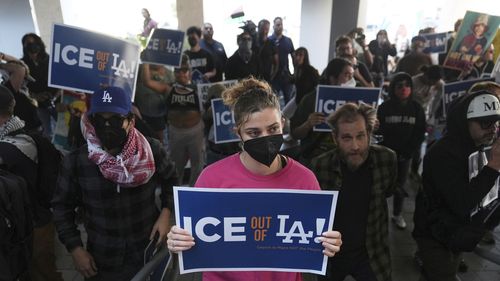 Protesters gather at the US Department of Justice Federal Bureau of Prisons after federal immigration authorities conducted an operation in Los Angeles.