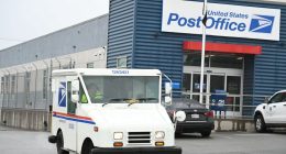 USPS mail truck leaving a post office.