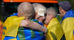 Ukrainian prisoners of war embracing after a prisoner exchange.