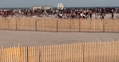 Police helicopter breaking up a beach brawl.