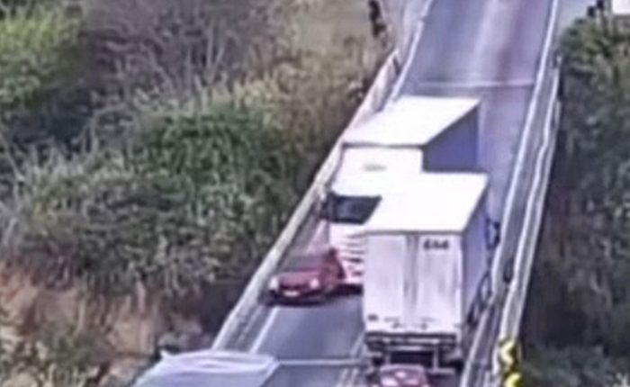 CCTV footage of a car being pushed off an overpass by a lorry.