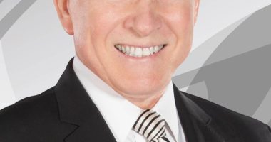 Headshot of Gary England in a suit.