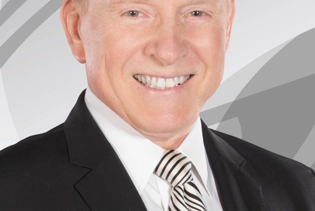 Headshot of Gary England in a suit.