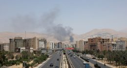 Smoke rises over a Tehran highway.