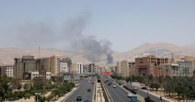 Smoke rises over a Tehran highway.